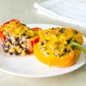 2 Chipotle Black Bean & Corn Stuffed Peppers on a white plate