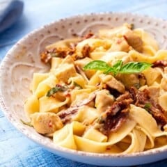 Sun-Dried Tomato Basil Sauce on fettuccini pasta and chicken in a bowl