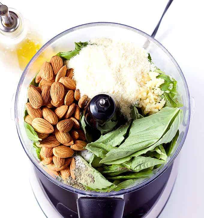 food processor full of Basil Pesto with Almonds ingredients