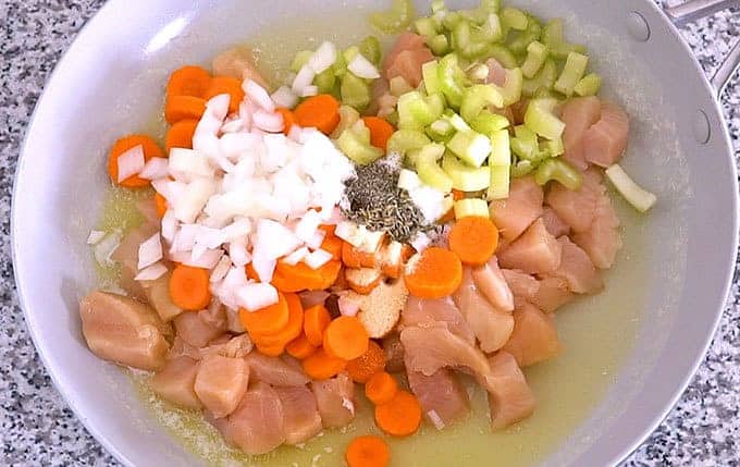 chicken breast, carrots, celery, onions, butter, salt, pepper, garlic powder, and dried thyme leaves in a skillet