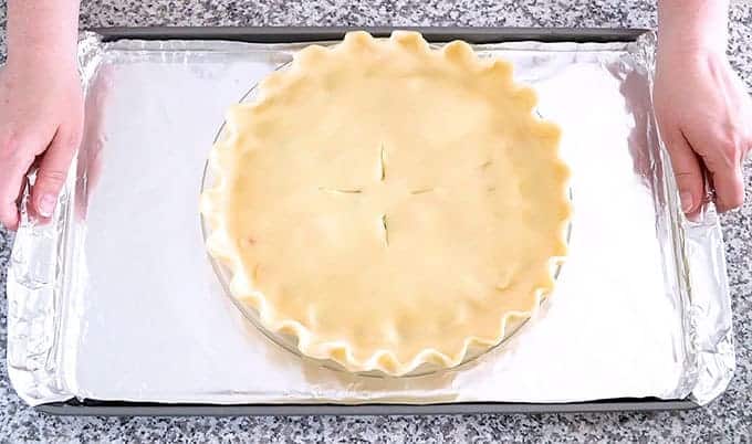 Unbaked chicken pot pie on a baking sheet