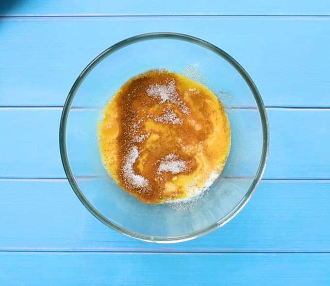 Bowl of the custard ingredients for french toast: eggs, milk, cinnamon, sugar, and vanilla