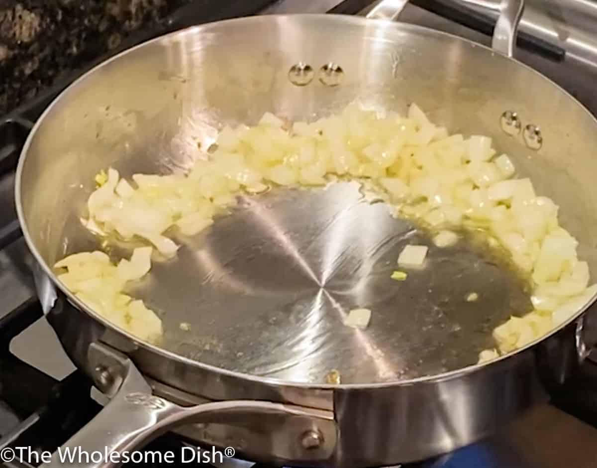 Onions sautéing in a skillet.