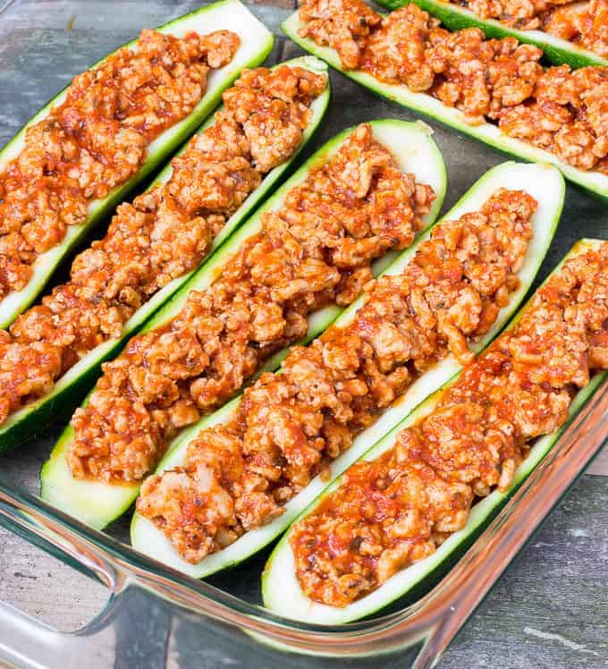 baking dish full of uncooked Chicken Parmesan Zucchini Boats