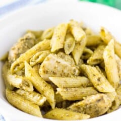 white bowl full of chicken pesto pasta