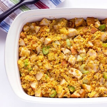 Large serving dish of corn bread stuffing with apples celery and onions