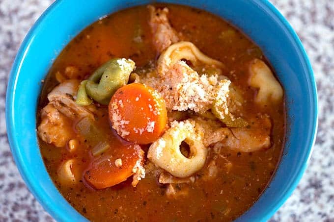 Crock Pot Italian Chicken Tortellini Soup in a blue serving bowl