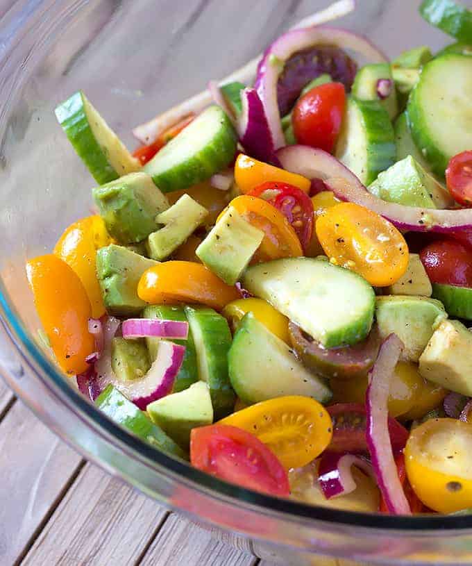 glass bowl full of Avocado Cucumber Tomato Salad with Balsamic Vinaigrette