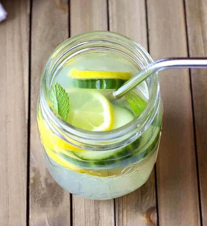 mason jar full of Cucumber Mint Lemonade  with a straw