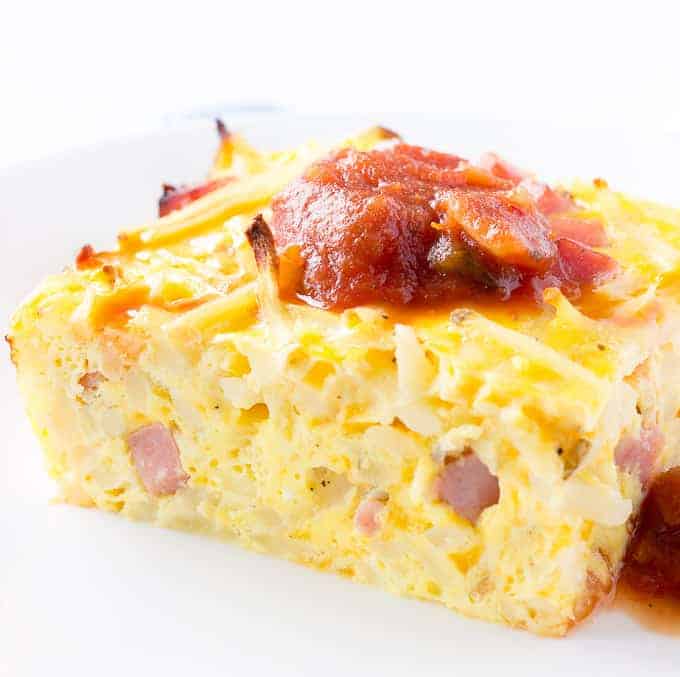 Slice of Hash Brown Breakfast Casserole with salsa on top