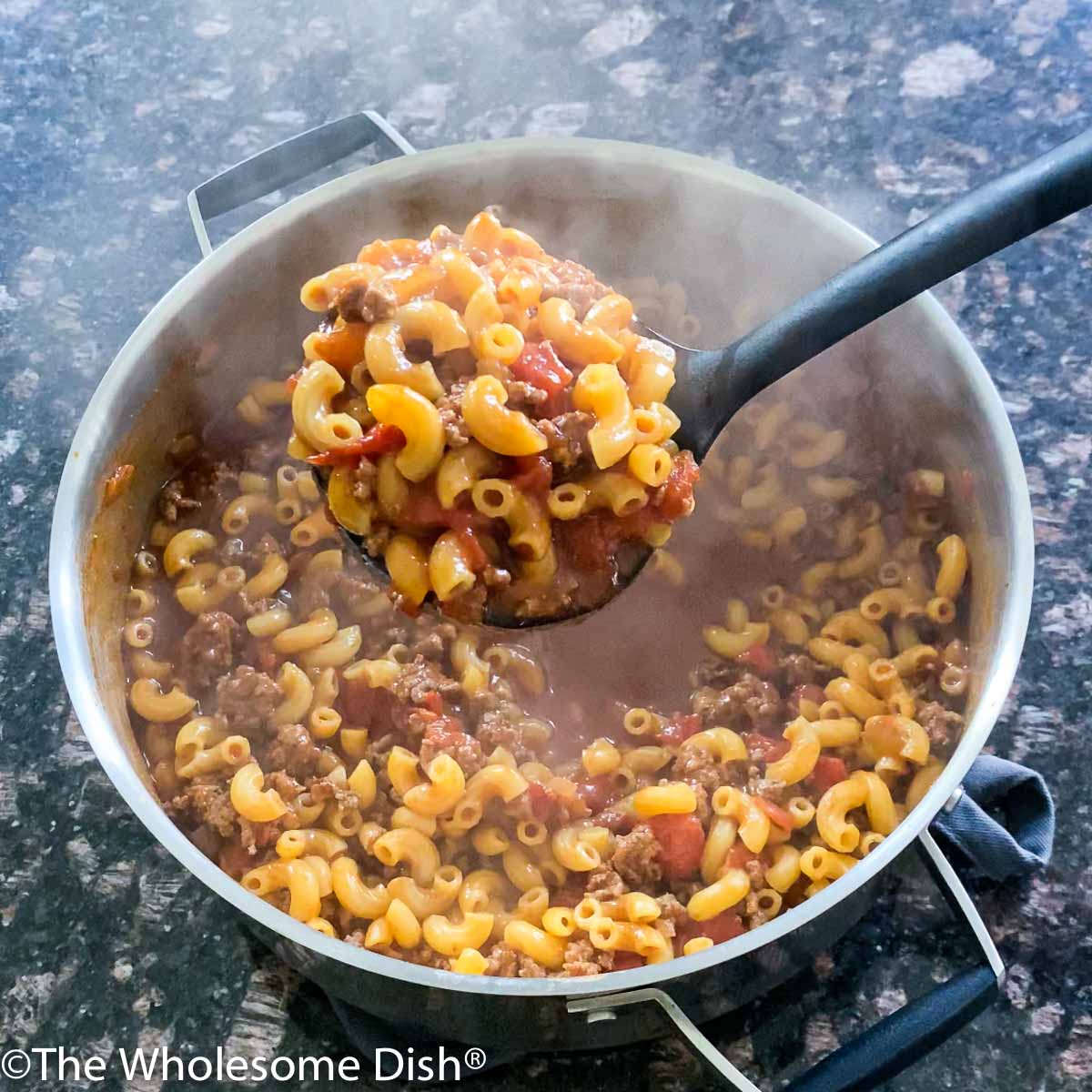 Large pot and a ladle full of chili mac