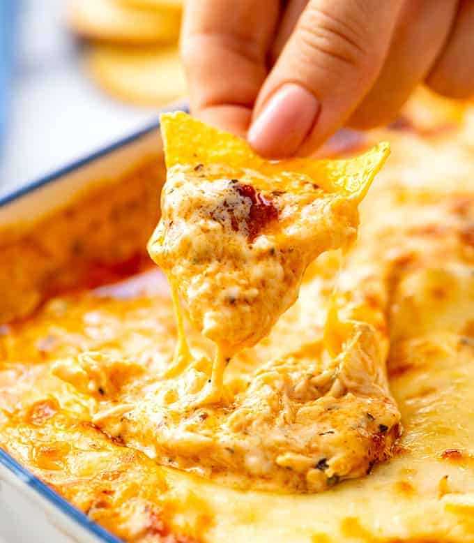 Tortilla chip covered in hot cheesy buffalo chicken dip