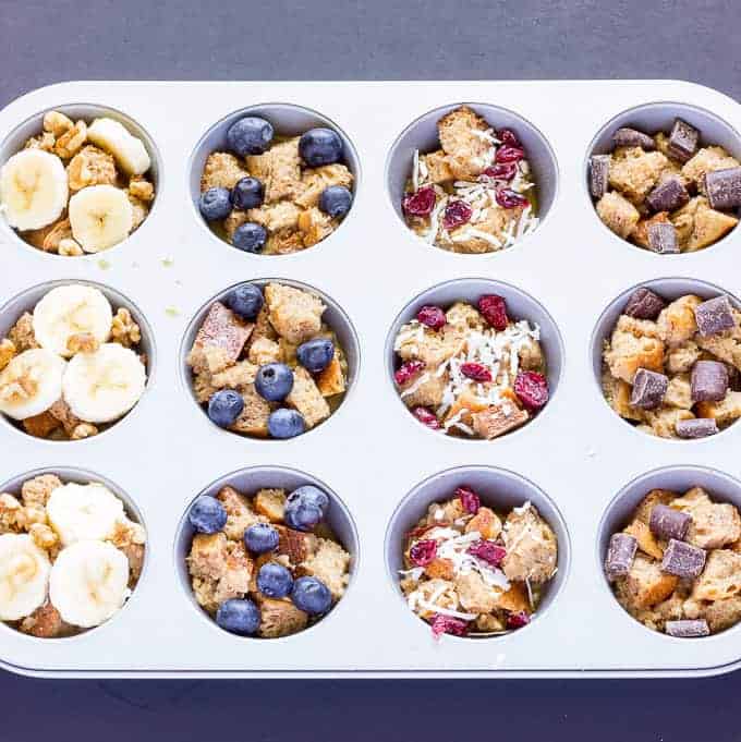 uncooked French Toast Cups with different Toppings in a muffin tin