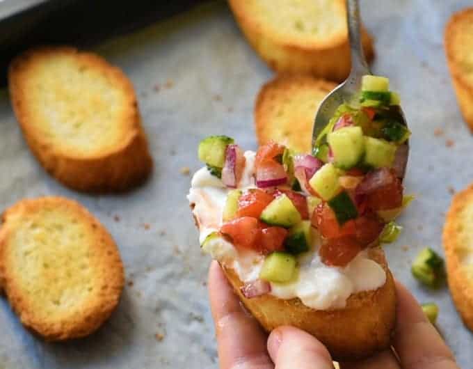 Greek seasoned veggies over feta spread on toast