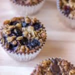 baked oatmeal muffins with different toppings on a cutting board