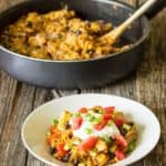 white bowl full of chicken enchilada skillet