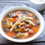 white bowl full of Italian Chicken Noodle Soup with Penne and Kale