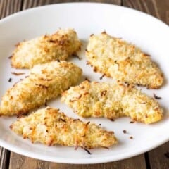 5 coconut chicken tenders on a white plate