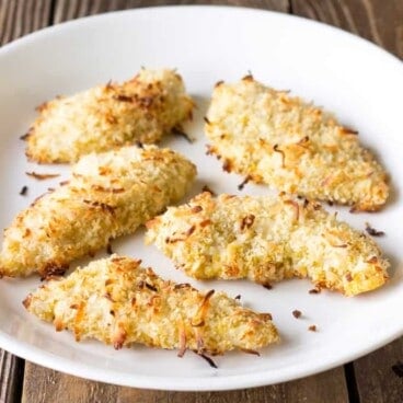 5 Baked Coconut Chicken Tenders on a white plate