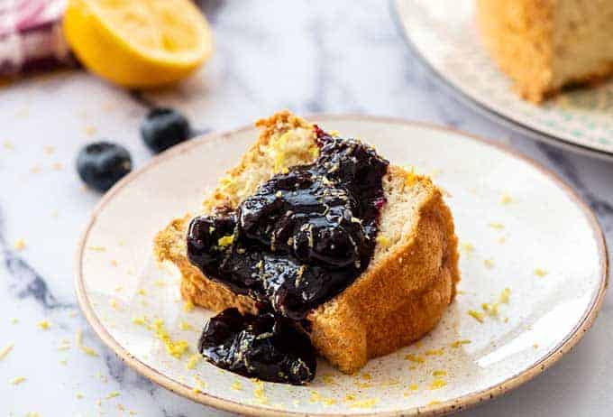 Blueberry Syrup on angel food cake on a plate