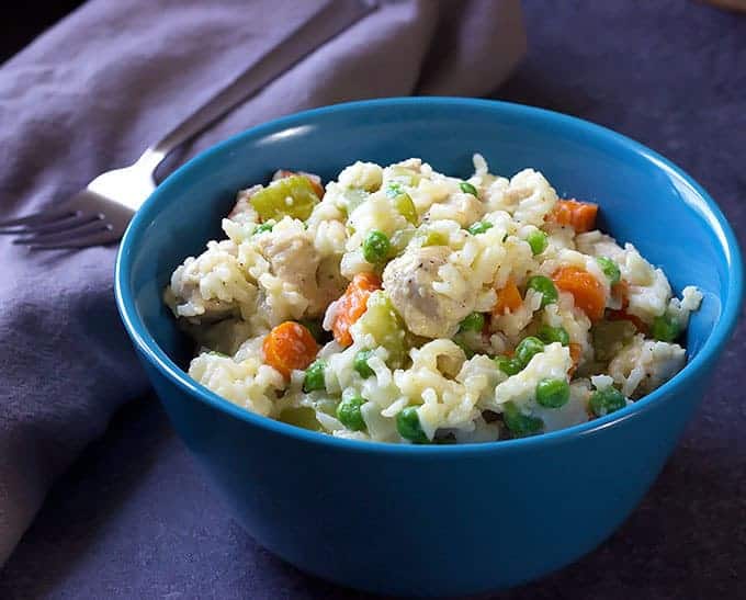 blue bowl full of One Pot Creamy Chicken and Rice