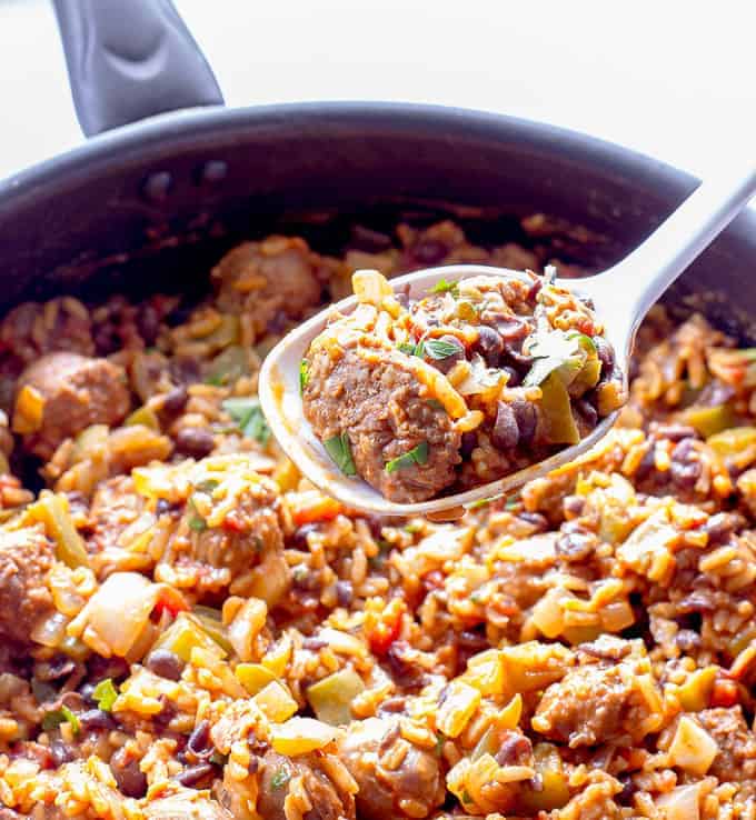 skillet and spoon full of One Pot Wonder Spanish Rice with Chorizo