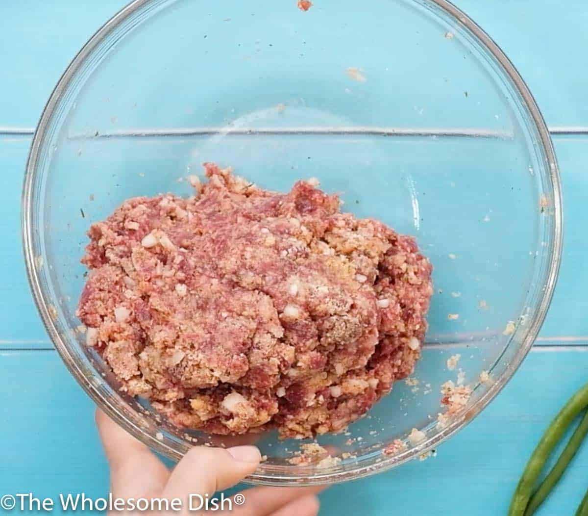 mixing bowl full of meatloaf mixture ready to cook