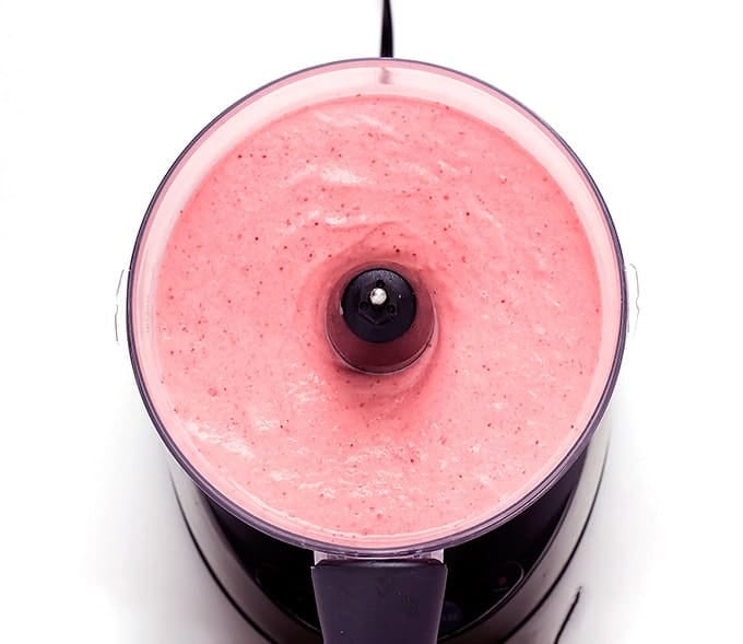 food processor full of strawberry banana frozen yogurt