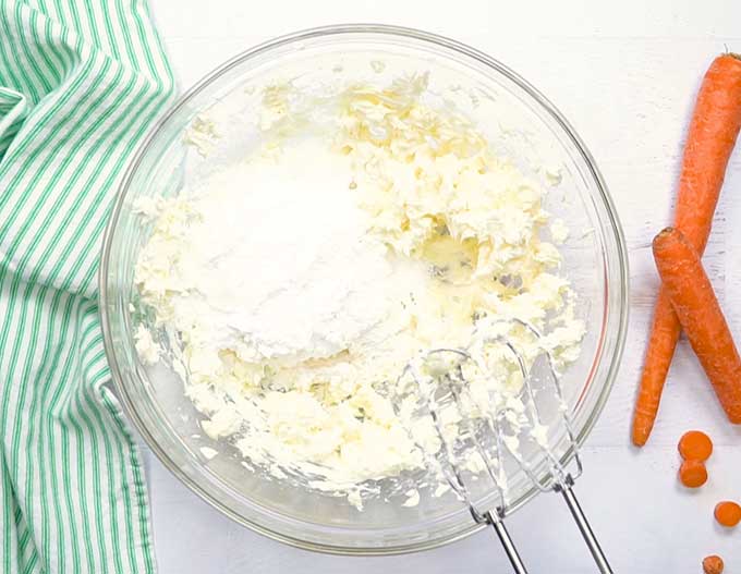 Mixing the cream cheese frosting for carrot cake - made of cream cheese, butter, vanilla, and powdered sugar