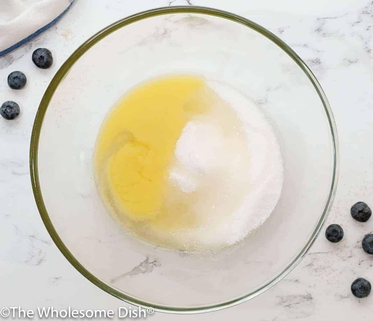 Mixing bowl with melted butter, sugar, and oil.