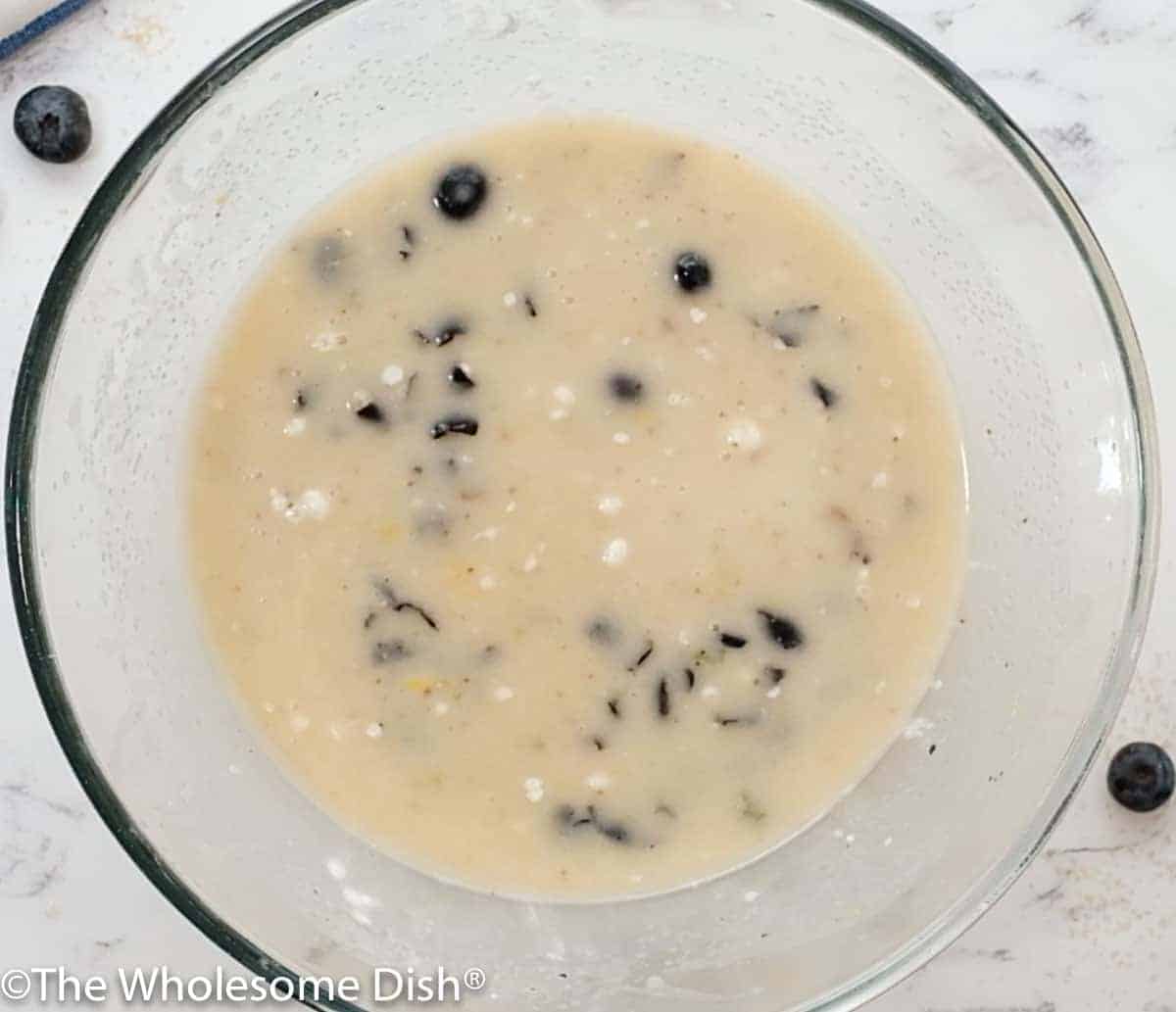 Mixing bowl with wet ingredients for blueberry muffin batter.