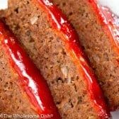 Three slices of meatloaf with ketchup glaze on top.