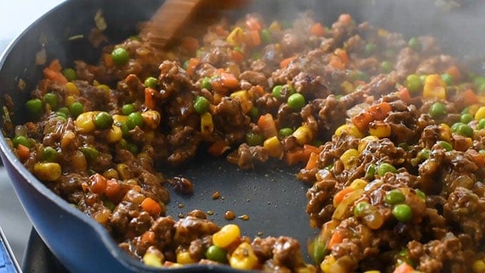 Skillet full of the seasoned meat and vegetable gravy for Irish Shepherd's Pie