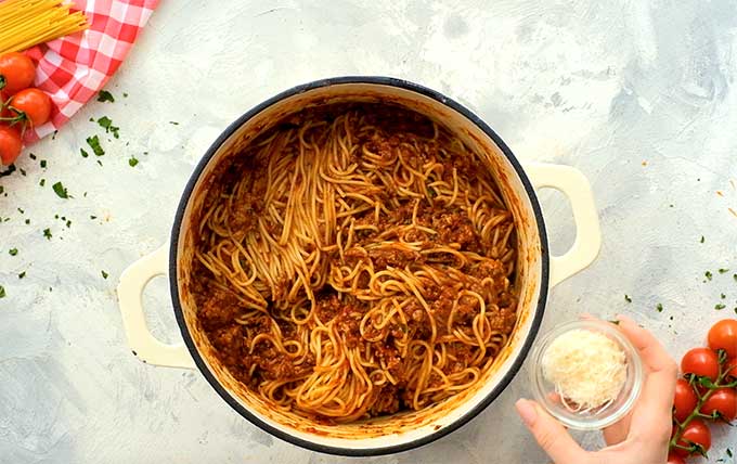 large pot full of cooked spaghetti coated in spaghetti sauce